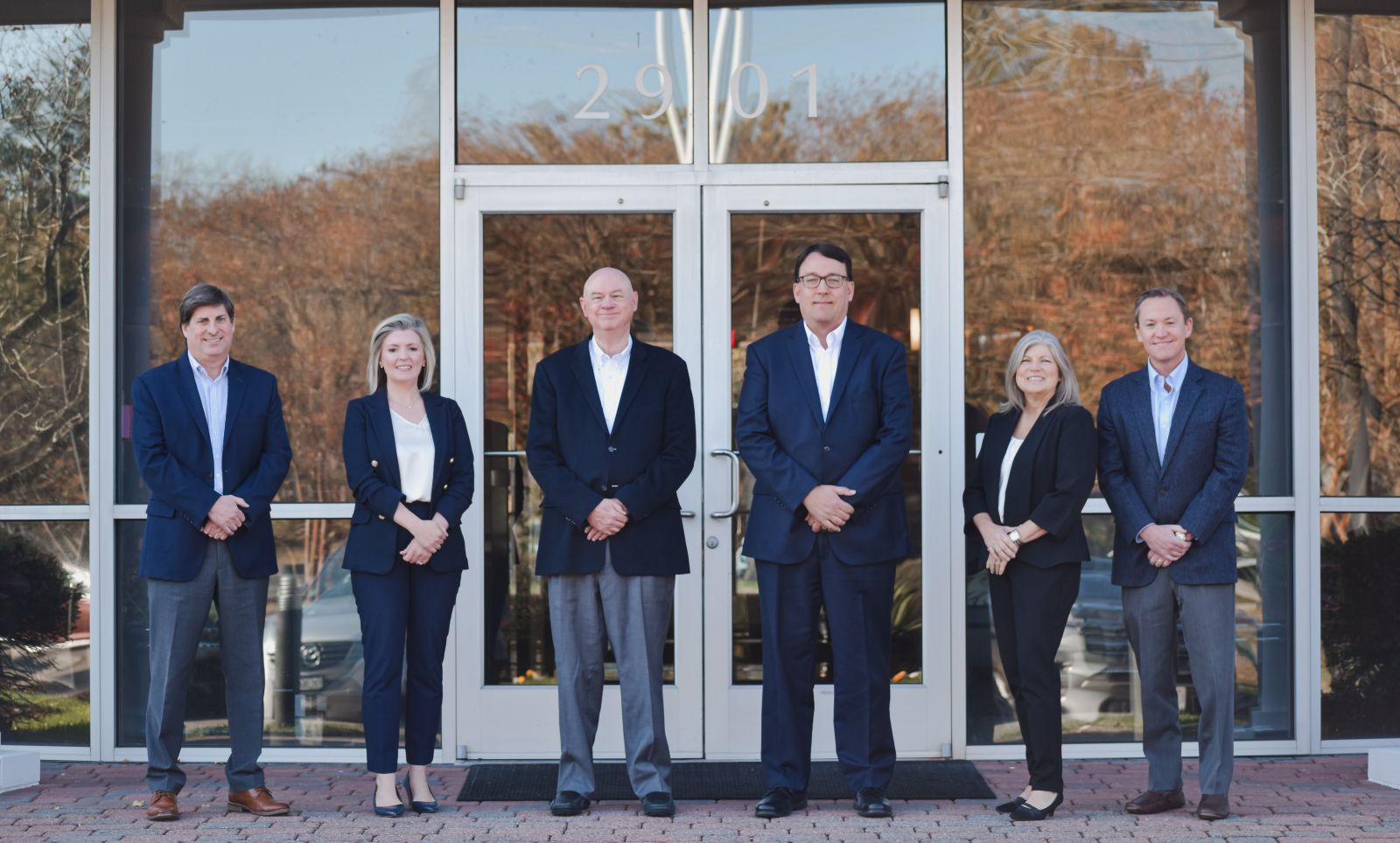 smiling woman in room with team